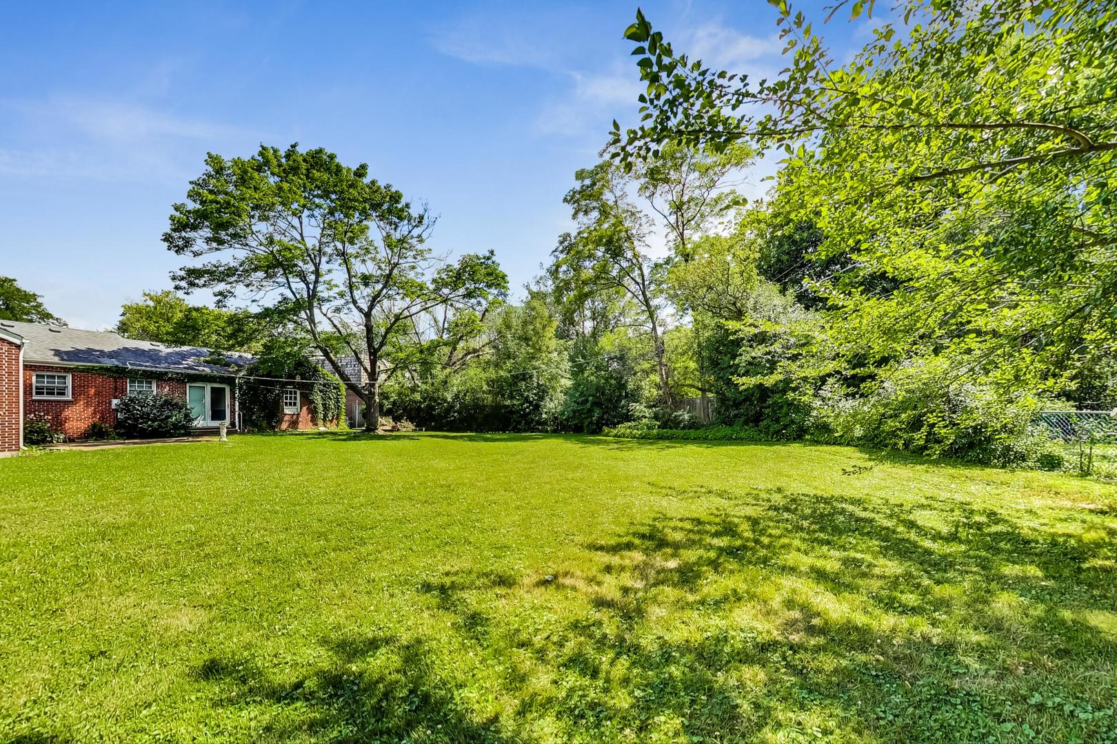 580 North Happ Road Northfield, IL 60093 - Photo 46 of 49 a view of a big yard with a house