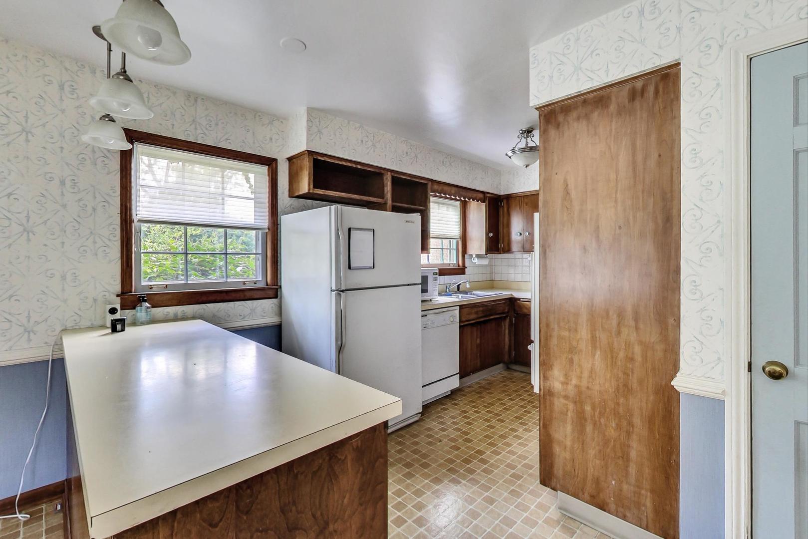 580 North Happ Road Northfield, IL 60093 - Photo 7 of 49 a kitchen with kitchen island a sink appliances and cabinets