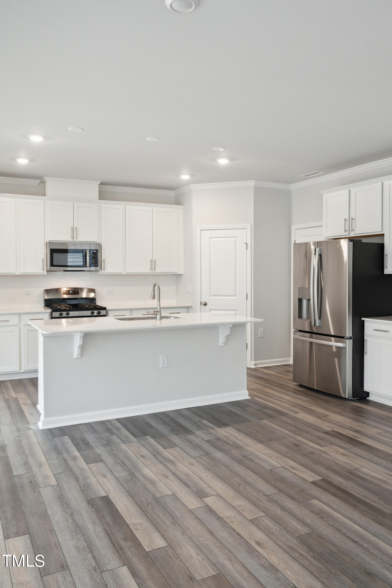 532 Hanover Shore Lane Raleigh, NC 27610 - Photo 11 of 31 a kitchen with stainless steel appliances a refrigerator sink and microwave