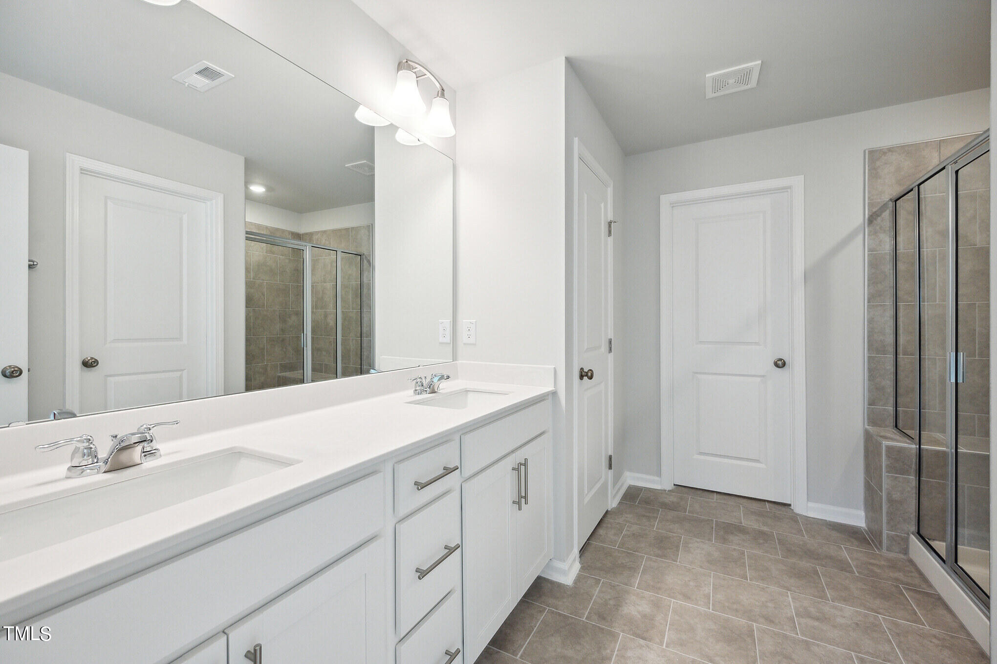 532 Hanover Shore Lane Raleigh, NC 27610 - Photo 22 of 31 a spacious bathroom with a double vanity sink mirror and double