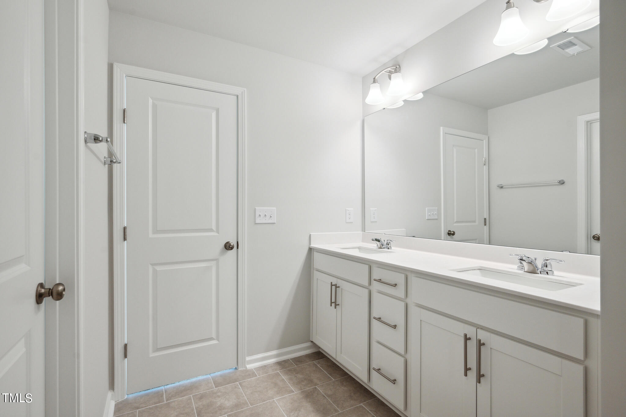 532 Hanover Shore Lane Raleigh, NC 27610 - Photo 24 of 31 a bathroom with a double vanity sink and mirror