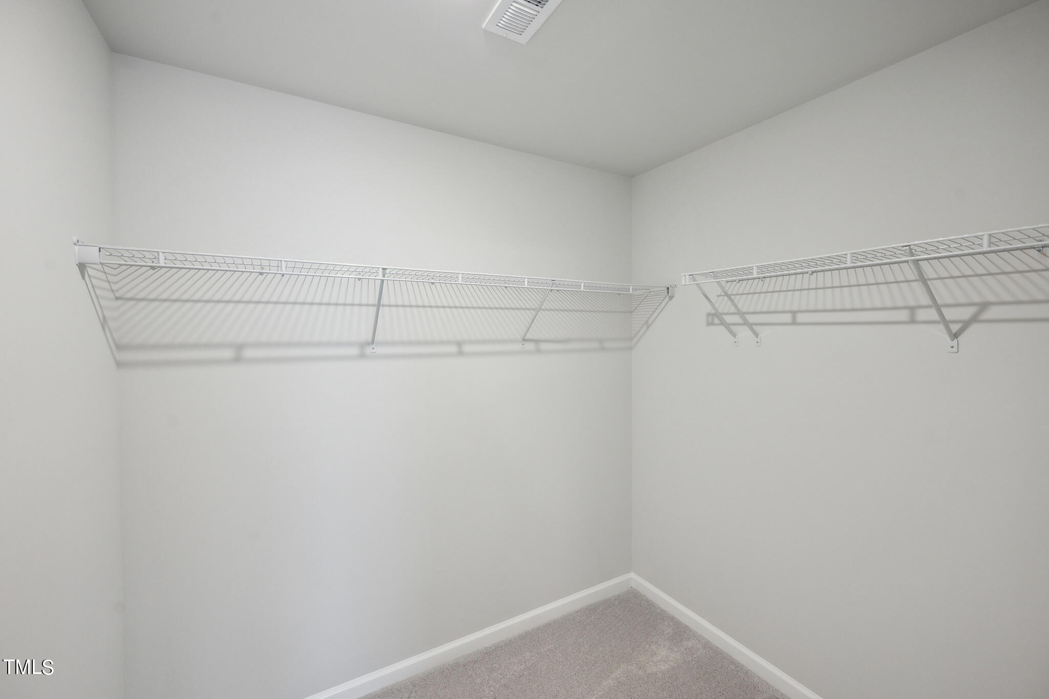532 Hanover Shore Lane Raleigh, NC 27610 - Photo 26 of 31 a view of a room with racks on the wall