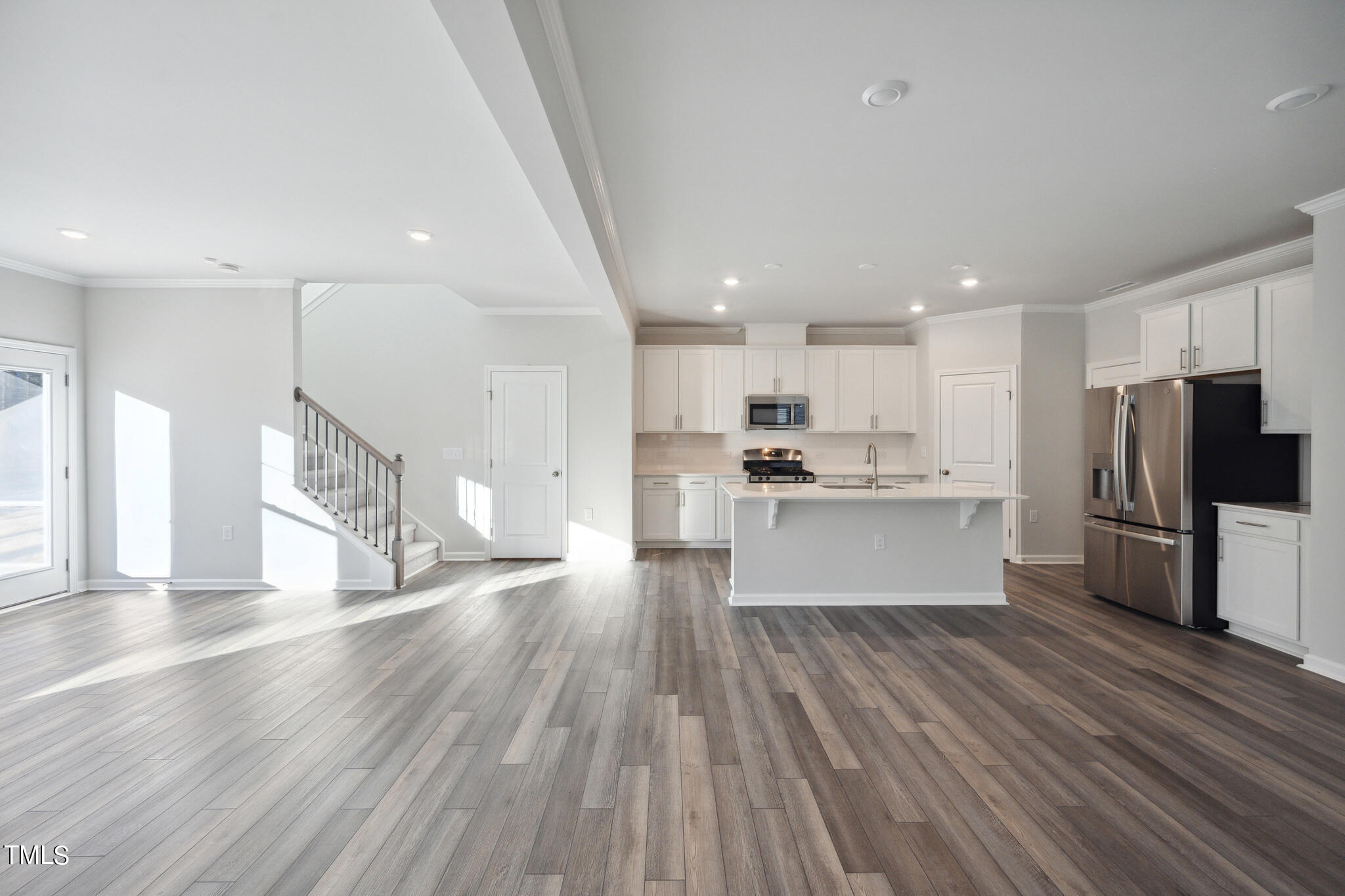 532 Hanover Shore Lane Raleigh, NC 27610 - Photo 5 of 31 a view of kitchen with refrigerator microwave and wooden floor