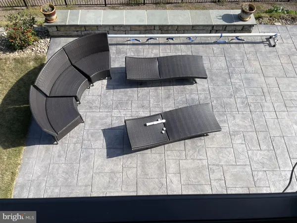 a view of a porch with furniture and floor to ceiling window