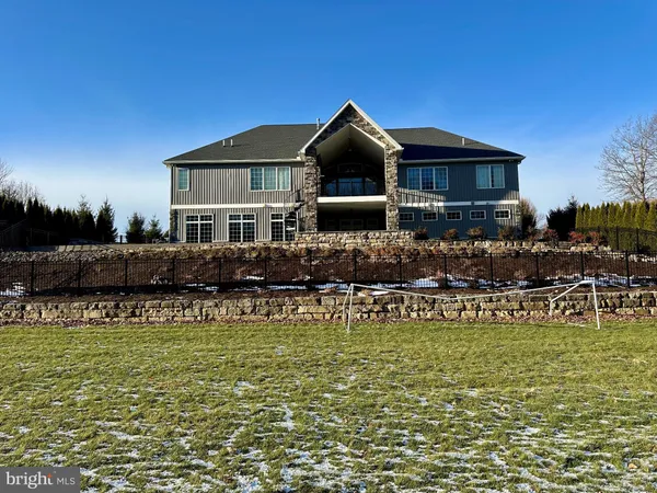 a front view of a house with swimming pool having outdoor seating