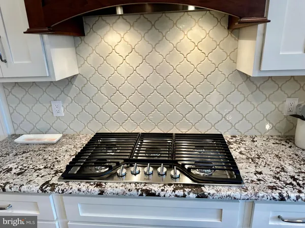 a kitchen with furniture and a stove