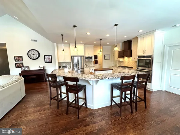 a large kitchen with a table and chairs