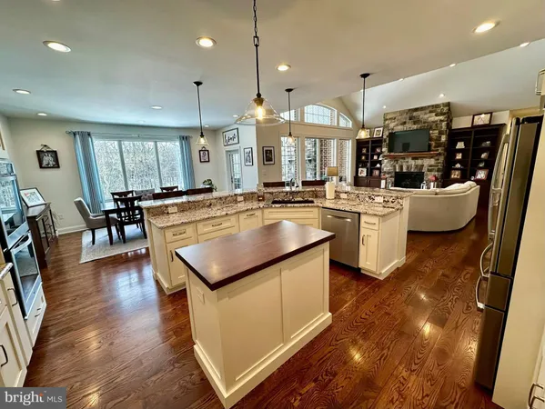 a kitchen with stainless steel appliances granite countertop a cabinets and a stove