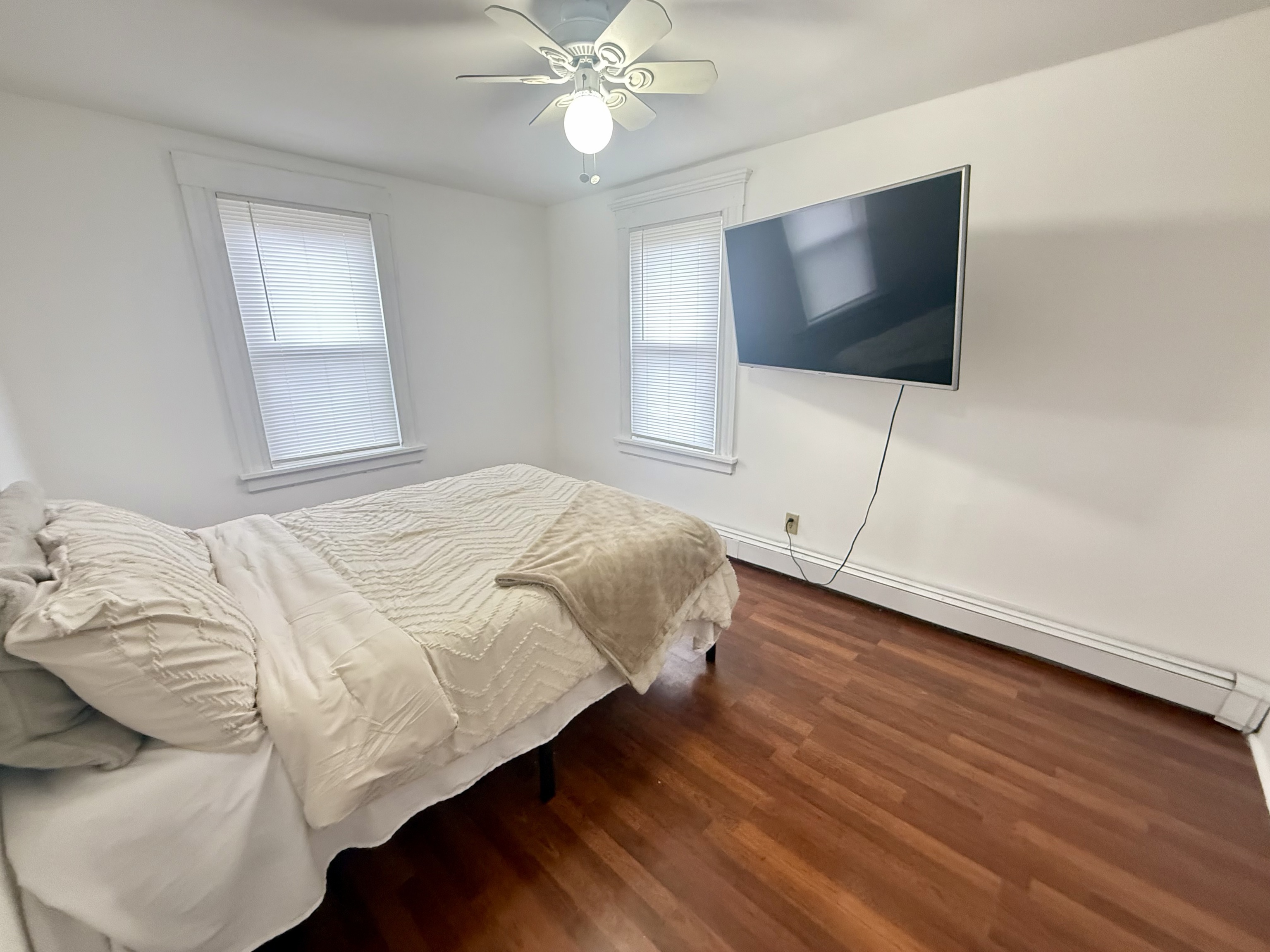 419 Huntington Road Stratford, CT 06614 - Photo 11 of 40 a bedroom with a bed and a flat screen tv