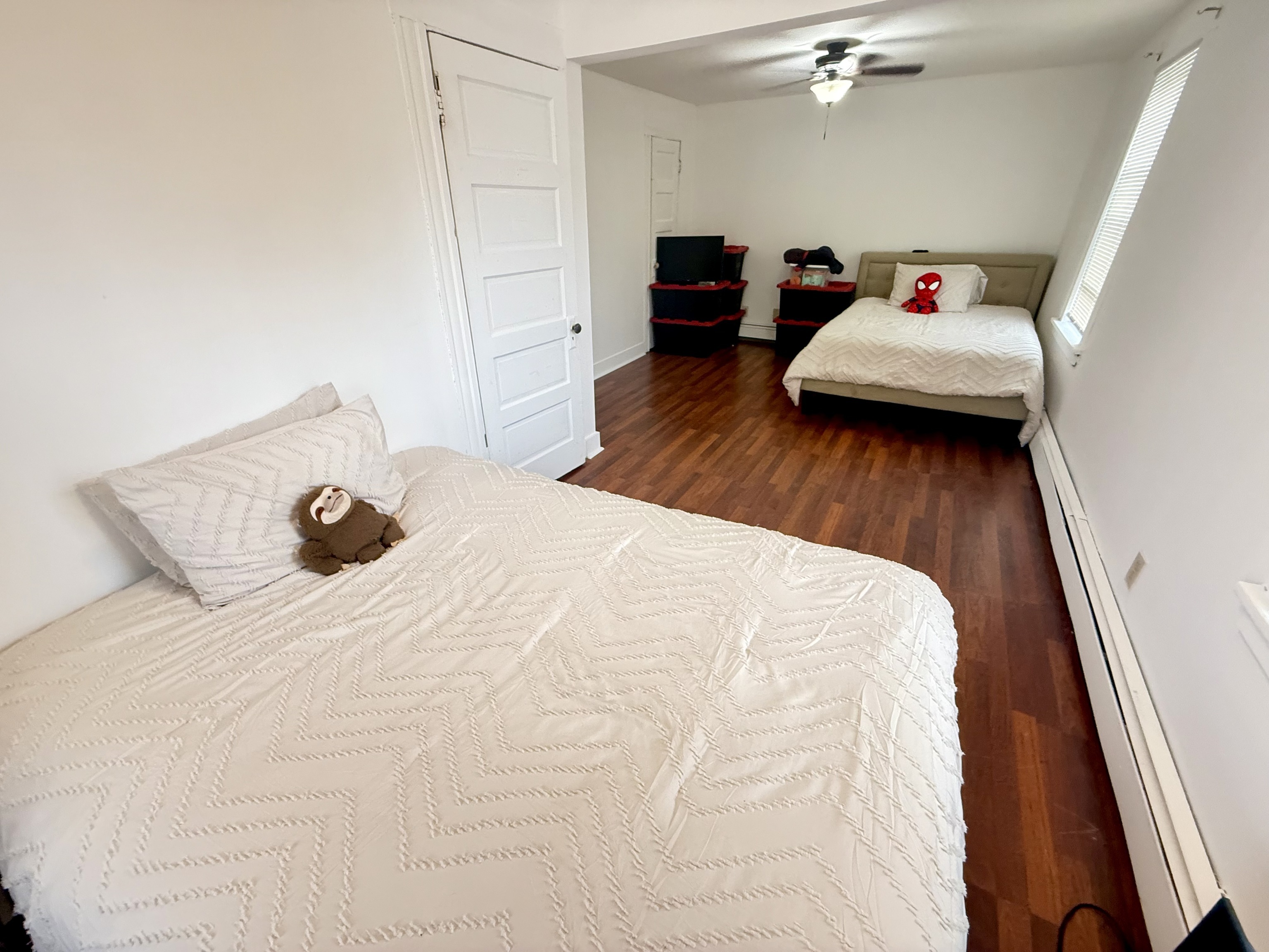 419 Huntington Road Stratford, CT 06614 - Photo 14 of 40 a bedroom with a bed and wooden floor