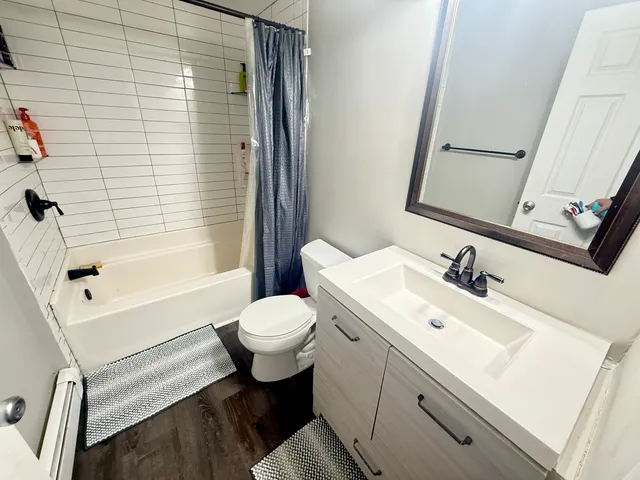 a bathroom with a sink toilet and shower