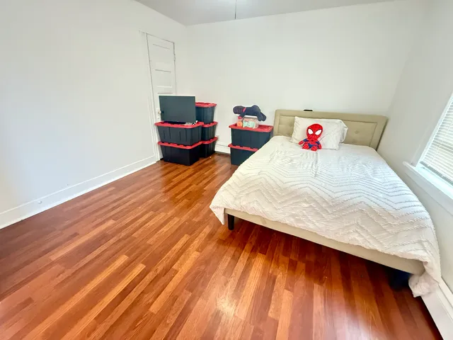 a room with wooden floor and furniture