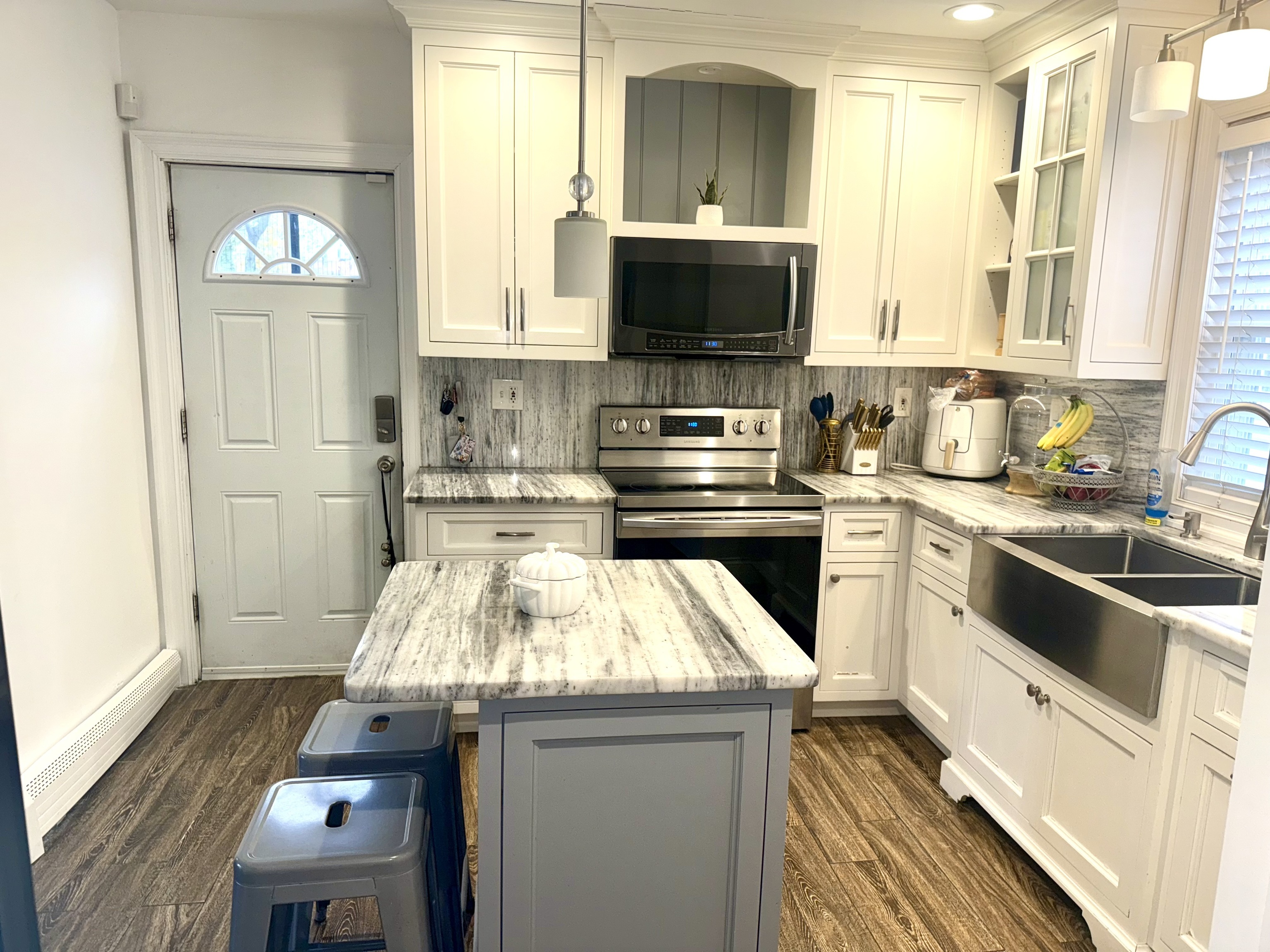 419 Huntington Road Stratford, CT 06614 - Photo 22 of 40 a kitchen with a stove a sink and a microwave