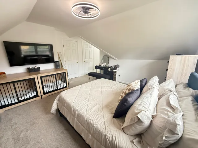 a bedroom with a bed and a flat screen tv