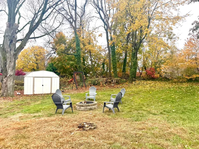a backyard of a house with table and chairs