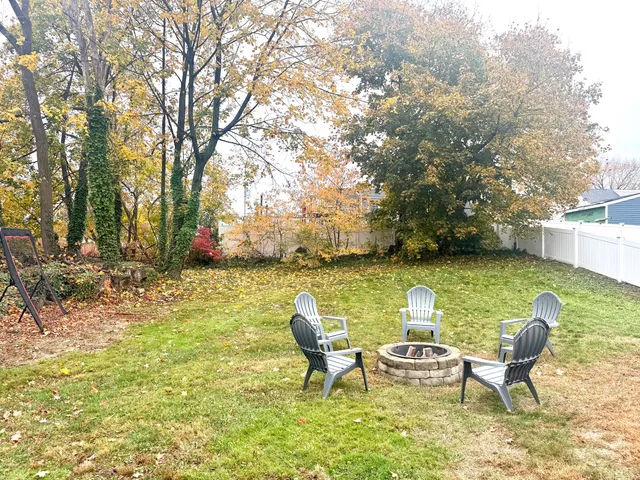 a view of a lake with table and chairs
