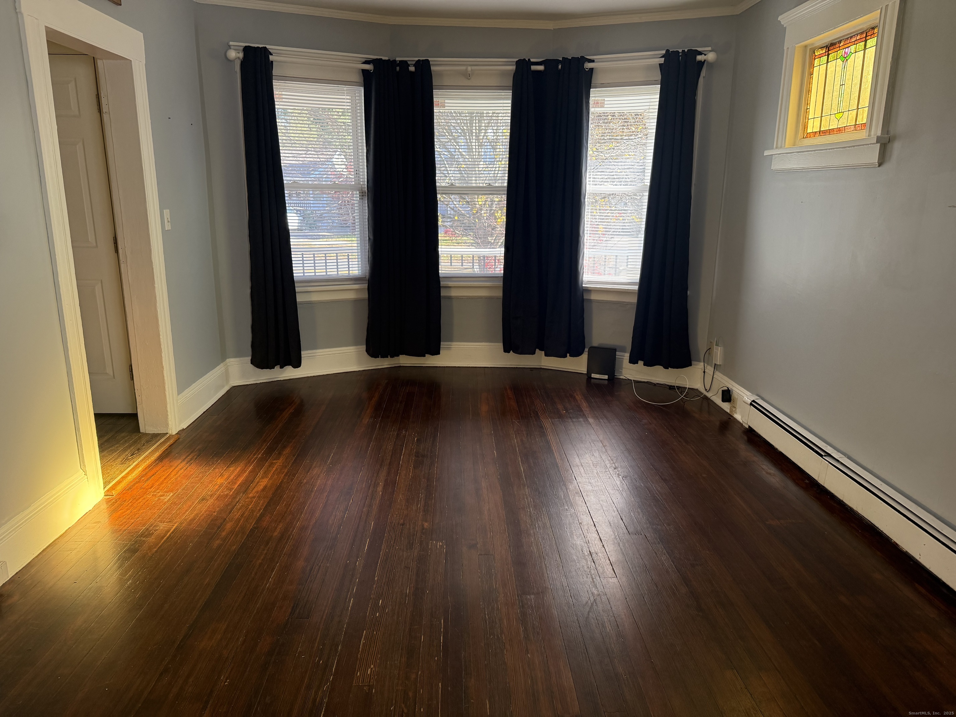 419 Huntington Road Stratford, CT 06614 - Photo 10 of 40 an empty room with wooden floor and windows