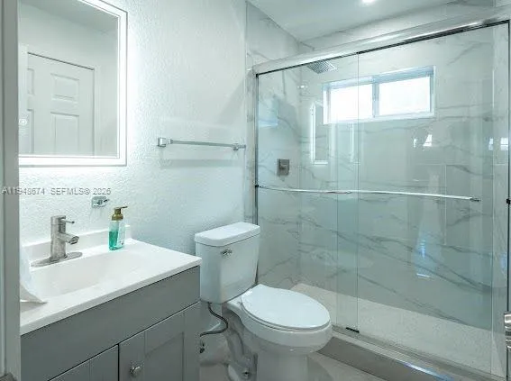 a bathroom with a sink toilet and shower