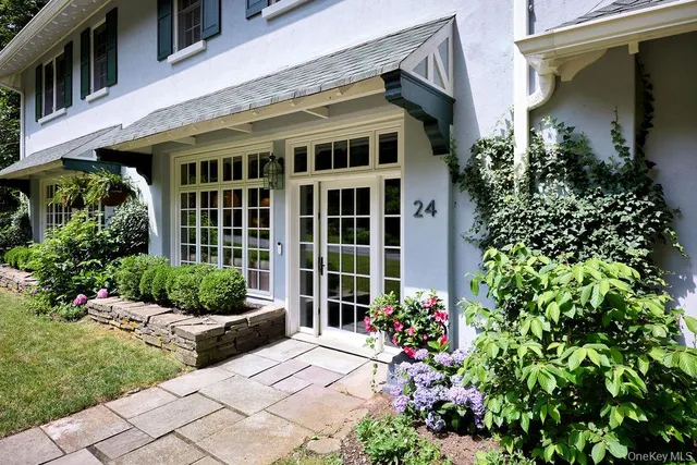 a front view of a house with a garden
