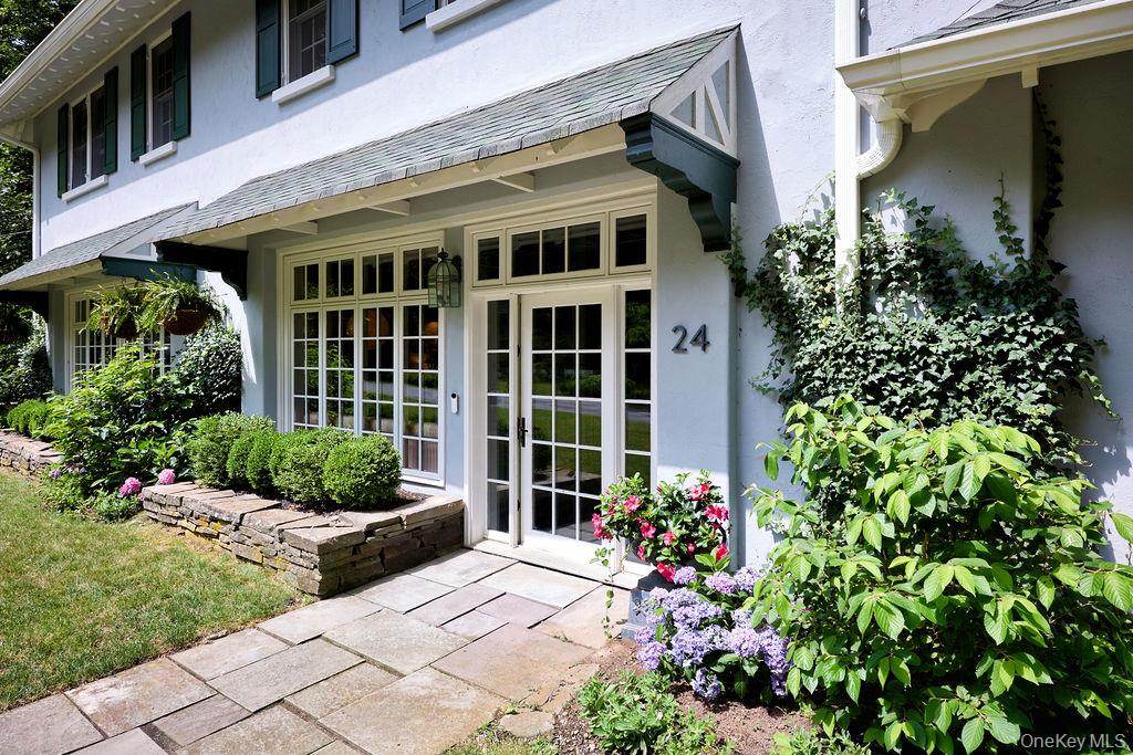 24 Acoma Road Tuxedo Park, NY 10987 - Photo 2 of 44 a front view of a house with a garden