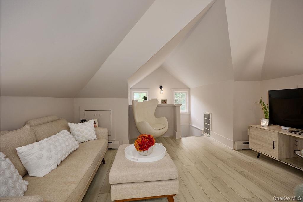 24 Acoma Road Tuxedo Park, NY 10987 - Photo 26 of 44 a living room with furniture and a flat screen tv