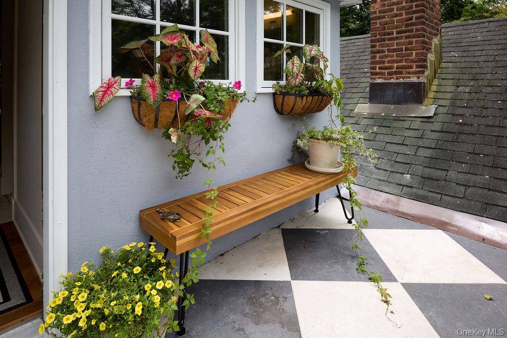 24 Acoma Road Tuxedo Park, NY 10987 - Photo 29 of 44 a bench with flowers in front of it