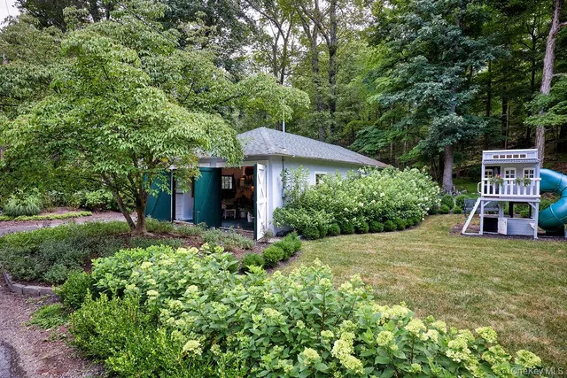a view of a chair and table in the backyard