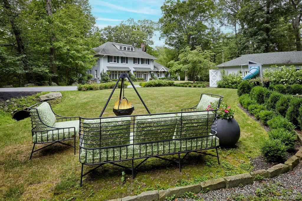 24 Acoma Road Tuxedo Park, NY 10987 - Photo 32 of 44 a view of a chair and table in the backyard