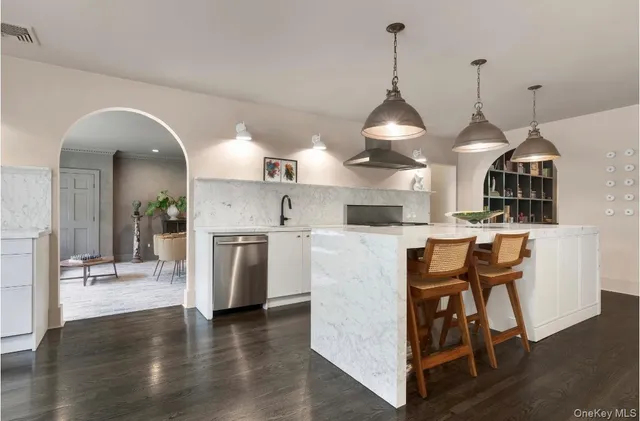 a view of a kitchen with furniture and wooden floor