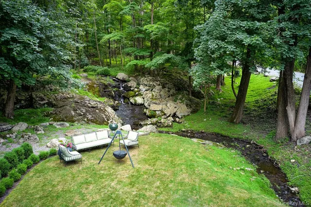 a view of a door of the house with a yard