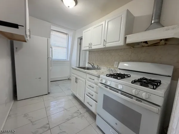 a kitchen with cabinets and appliances