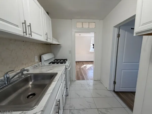 a kitchen with a sink and a stove top oven