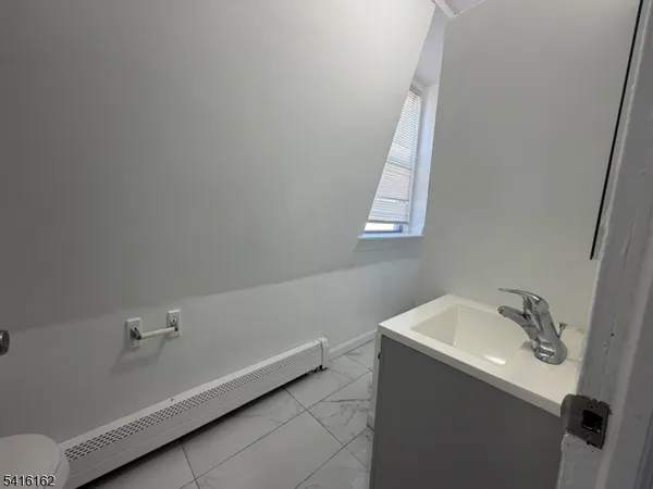 a bathroom with a bathtub sink and window