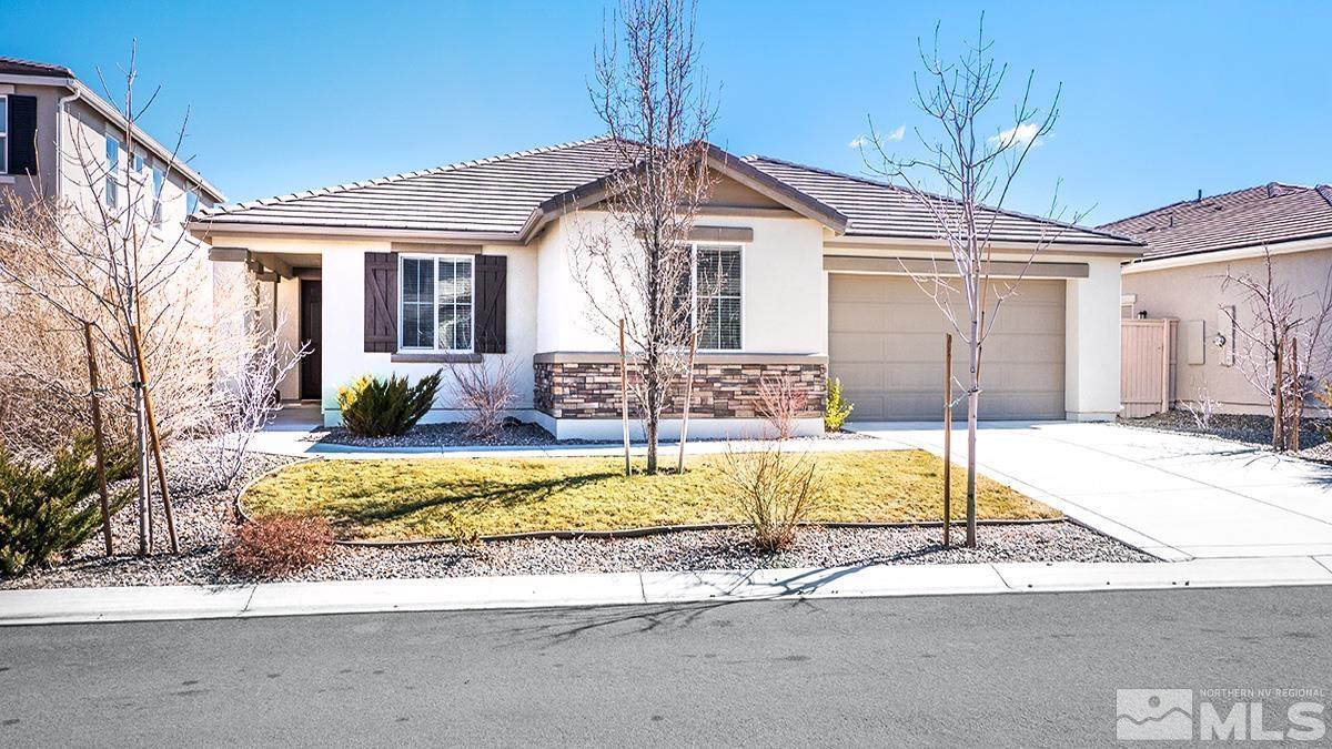 10250 Mott Drive Reno, NV 89521 - Photo 1 of 20 a front view of a house with a yard and garage