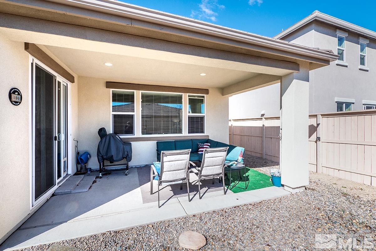 10250 Mott Drive Reno, NV 89521 - Photo 20 of 20 a view of a patio with table and chairs with wooden floor and fence
