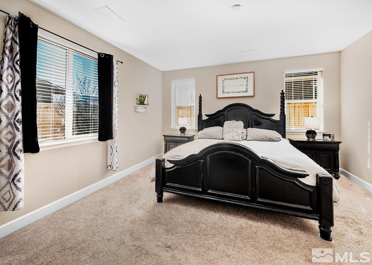 10250 Mott Drive Reno, NV 89521 - Photo 8 of 20 a spacious bedroom with a bed and wooden floor