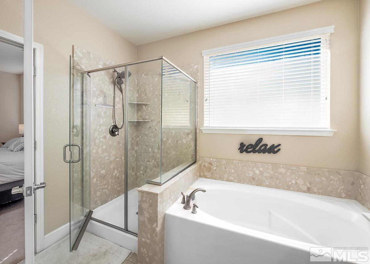 10250 Mott Drive Reno, NV 89521 - Photo 9 of 20 a bathroom with a bathtub and a shower