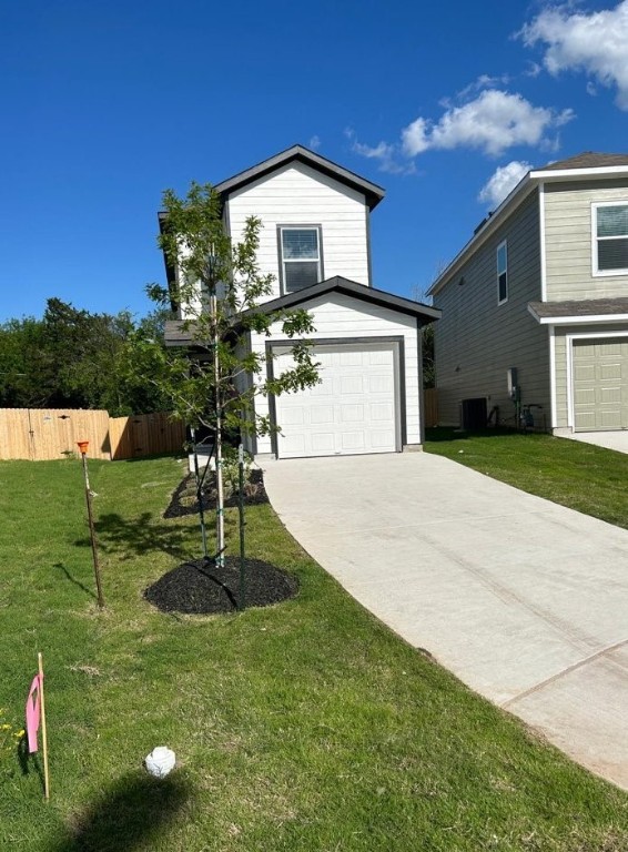 49 Trinity Circle Lockhart, TX 78644 - Photo 1 of 1 a front view of a house with a yard and garage