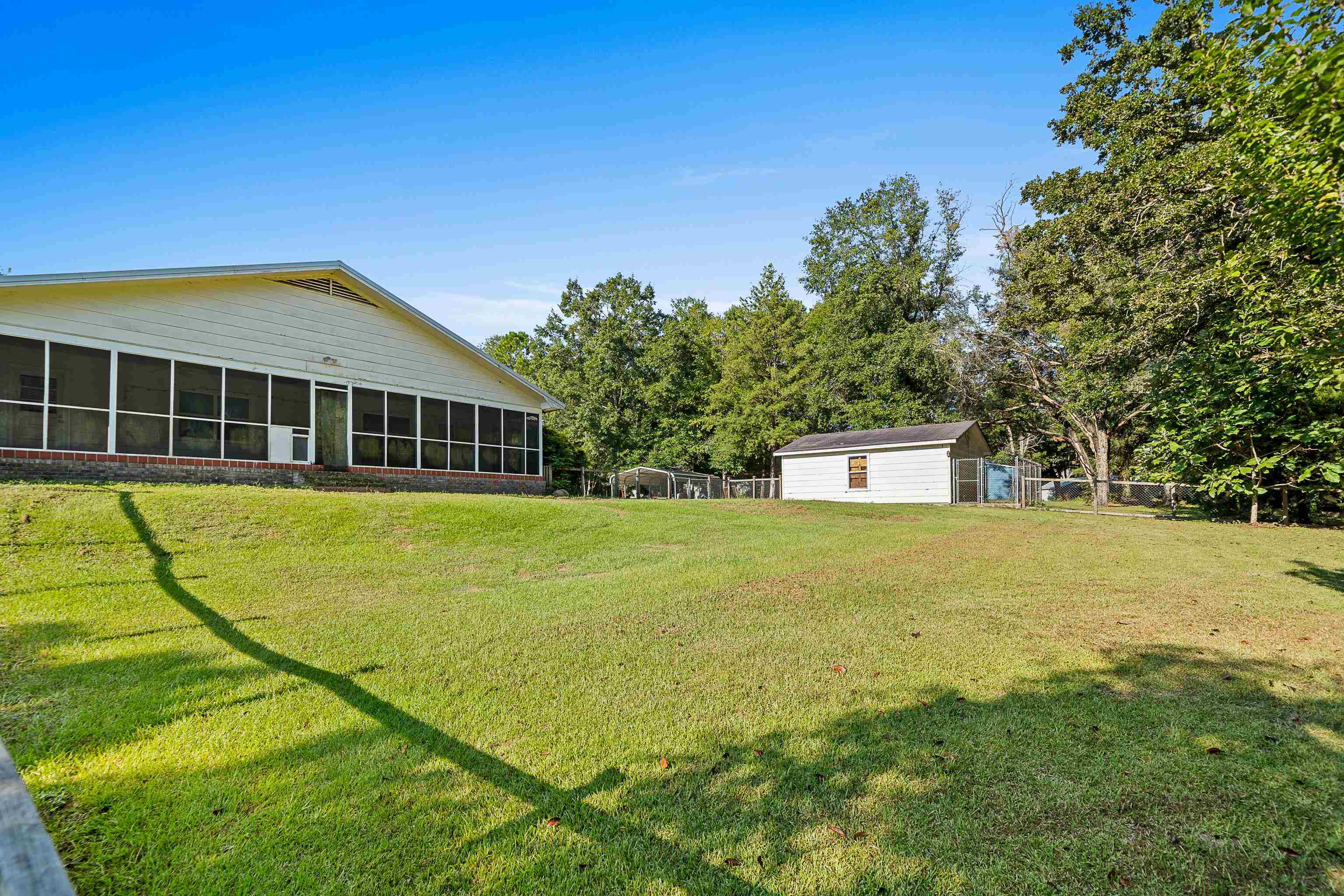 9350 Tompkins Road Stockton, AL 36579 - Photo 32 of 36 View of yard featuring a sunroom and an outdoor structure