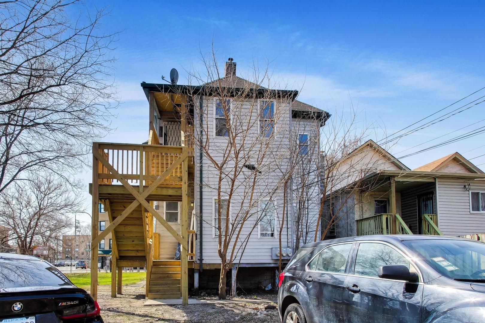 6853 South Perry Avenue Chicago, IL 60621 - Photo 25 of 28 a front view of a house with parking space