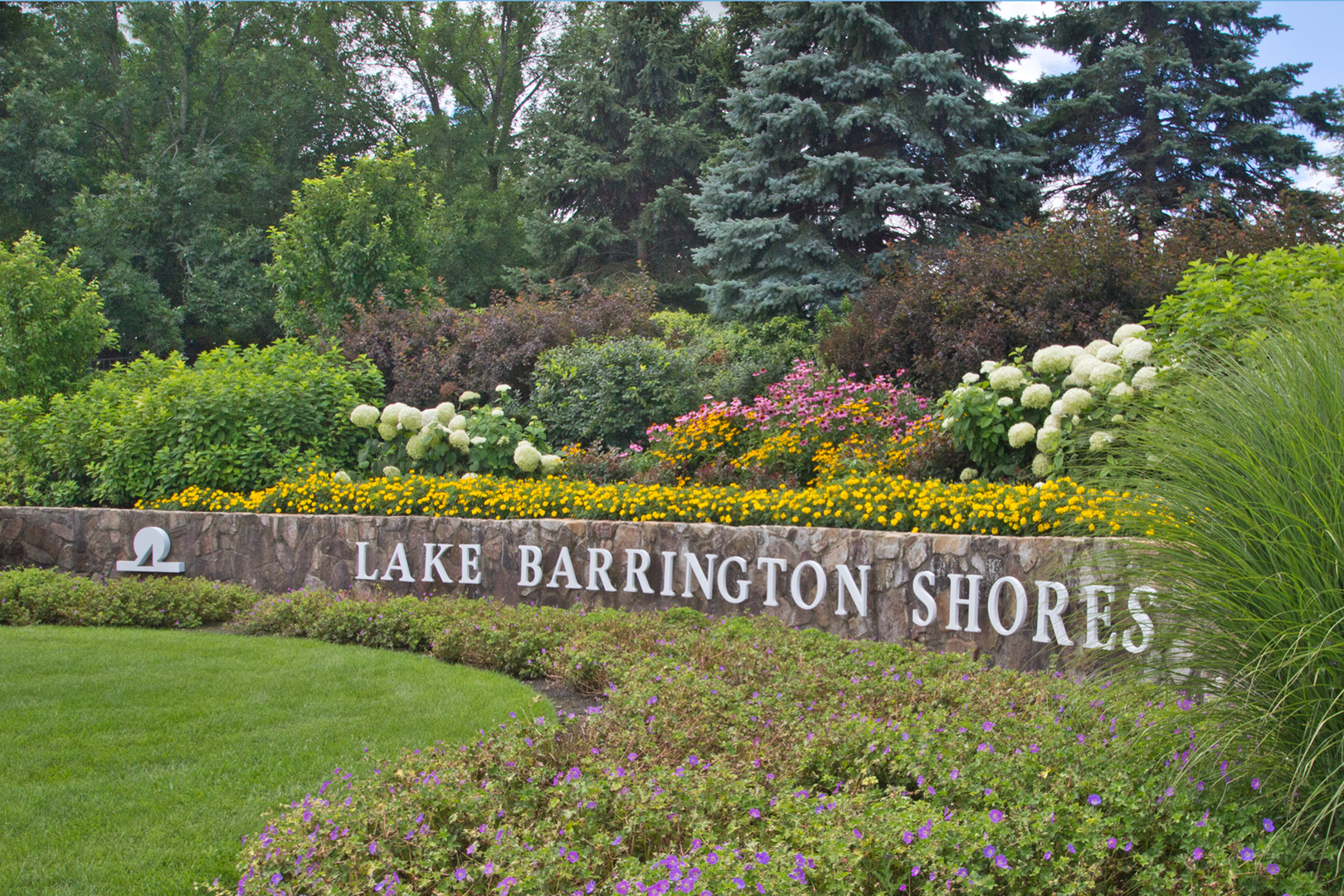 25 B Shoreline Road, Unit C345 Lake Barrington, IL 60010 - Photo 20 of 42 a view of outdoor space with signage and flags