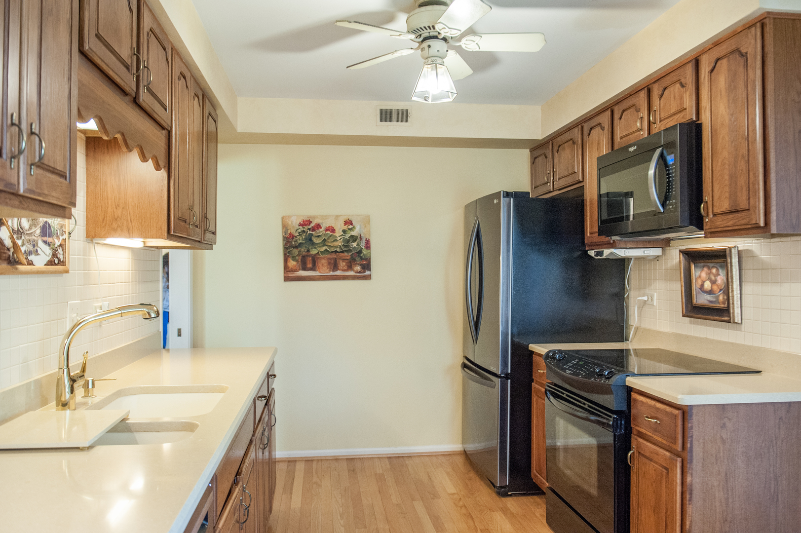 25 B Shoreline Road, Unit C345 Lake Barrington, IL 60010 - Photo 7 of 42 a kitchen with stainless steel appliances granite countertop a sink stove and refrigerator