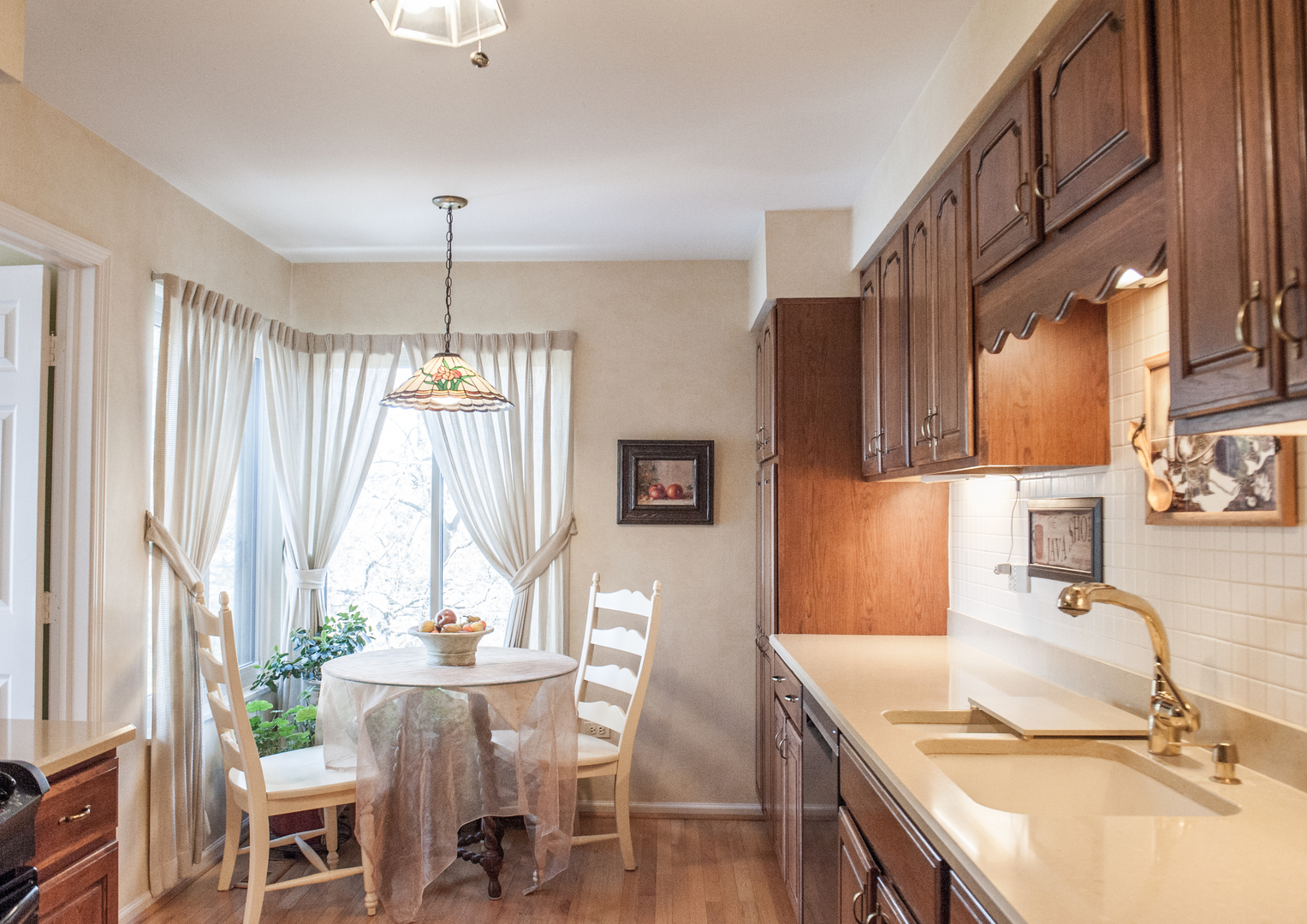 25 B Shoreline Road, Unit C345 Lake Barrington, IL 60010 - Photo 8 of 42 a kitchen with a table chairs and a sink