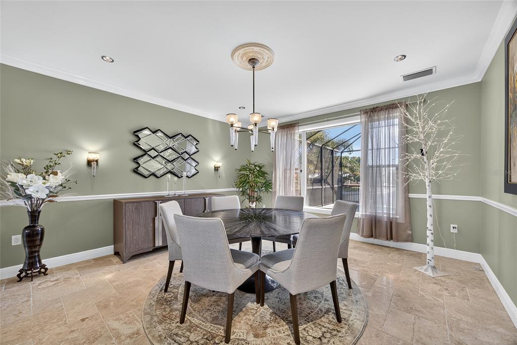 44 Colony Point Drive Punta Gorda, FL 33950 - Photo 15 of 84 a dining room with furniture a chandelier and window