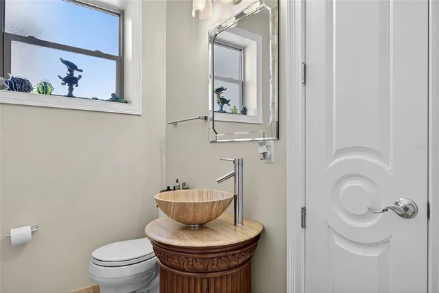 a kitchen with stainless steel appliances a sink counter space cabinets and a large window