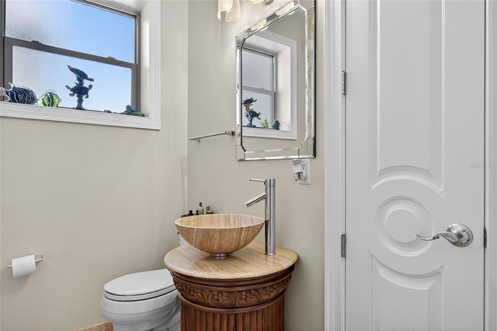 44 Colony Point Drive Punta Gorda, FL 33950 - Photo 16 of 84 a bathroom with a toilet a sink and mirror