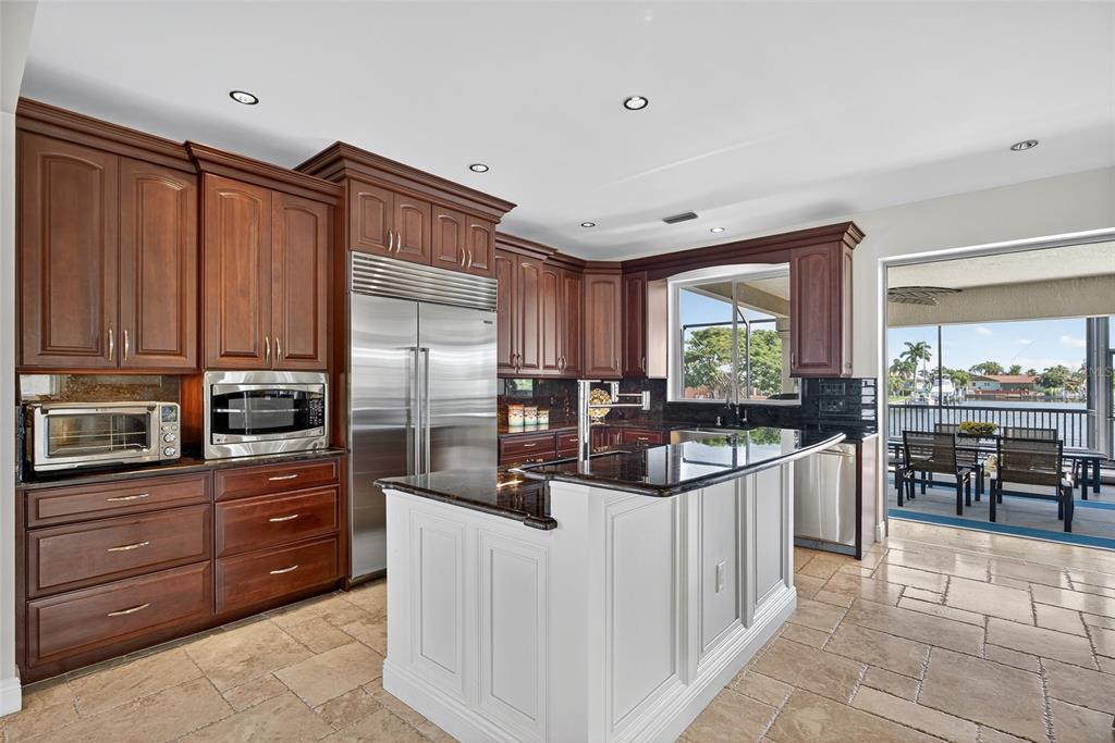 44 Colony Point Drive Punta Gorda, FL 33950 - Photo 22 of 84 a kitchen with stainless steel appliances a sink counter space cabinets and a large window