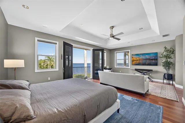 a balcony with wooden floor and outdoor seating