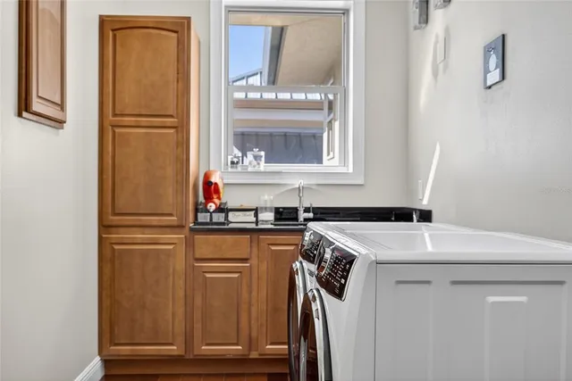 a living room with lots of furniture and view of kitchen