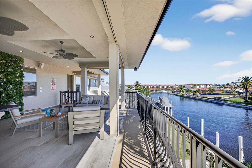 44 Colony Point Drive Punta Gorda, FL 33950 - Photo 59 of 84 a balcony with wooden floor and outdoor seating